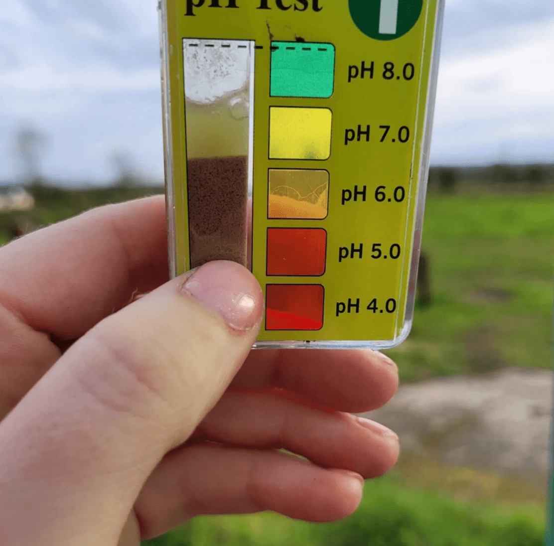soil ph tester being held up 
